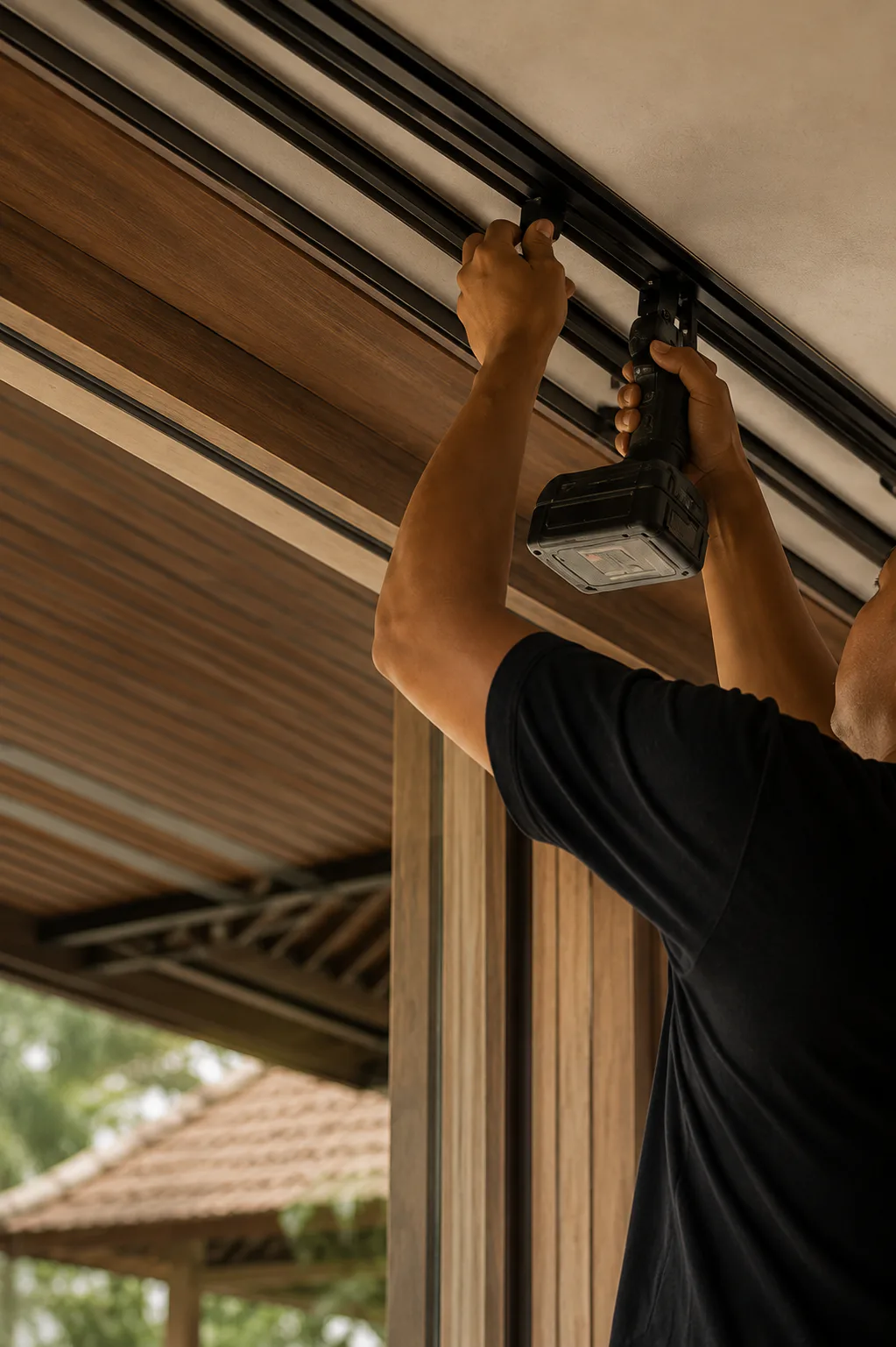 Technician installing a motorized window furnishing system